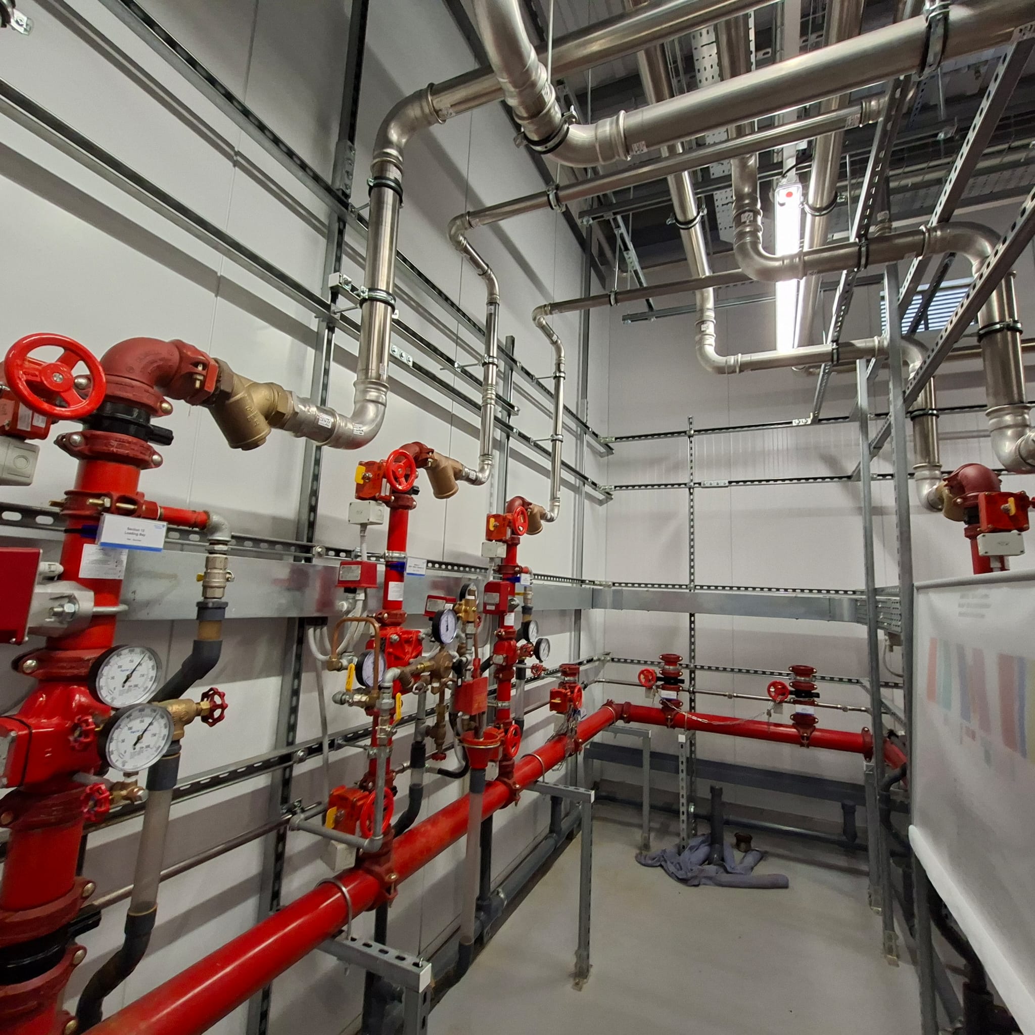 Stainless steel high-velocity discharge nozzles mounted on distribution grid